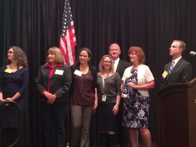 Members of SANE staff receiving the 2014 Non-Profit of the Year Award